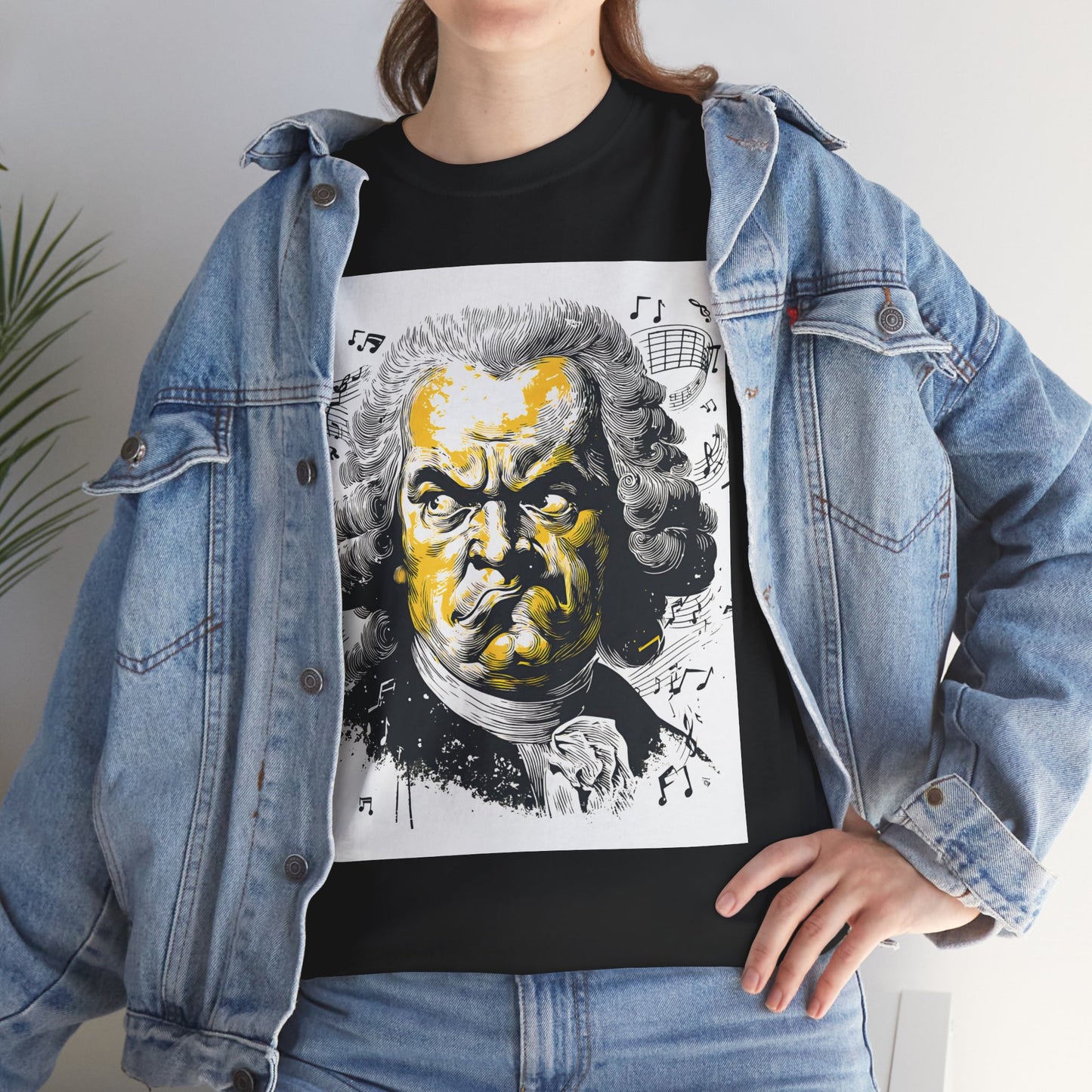 Person wearing a black t-shirt with a graphic design of a famous composer, paired with a denim jacket.