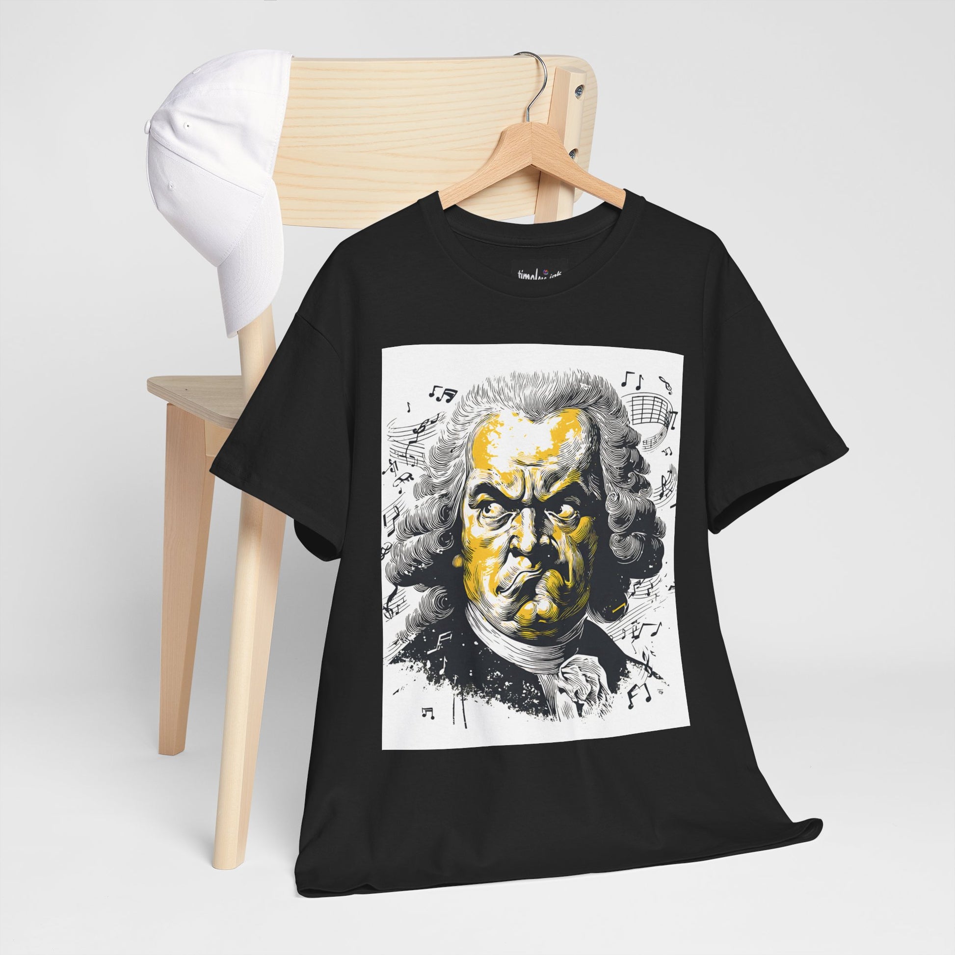 Black t-shirt with a graphic design of a famous composer on a wooden hanger against a white background