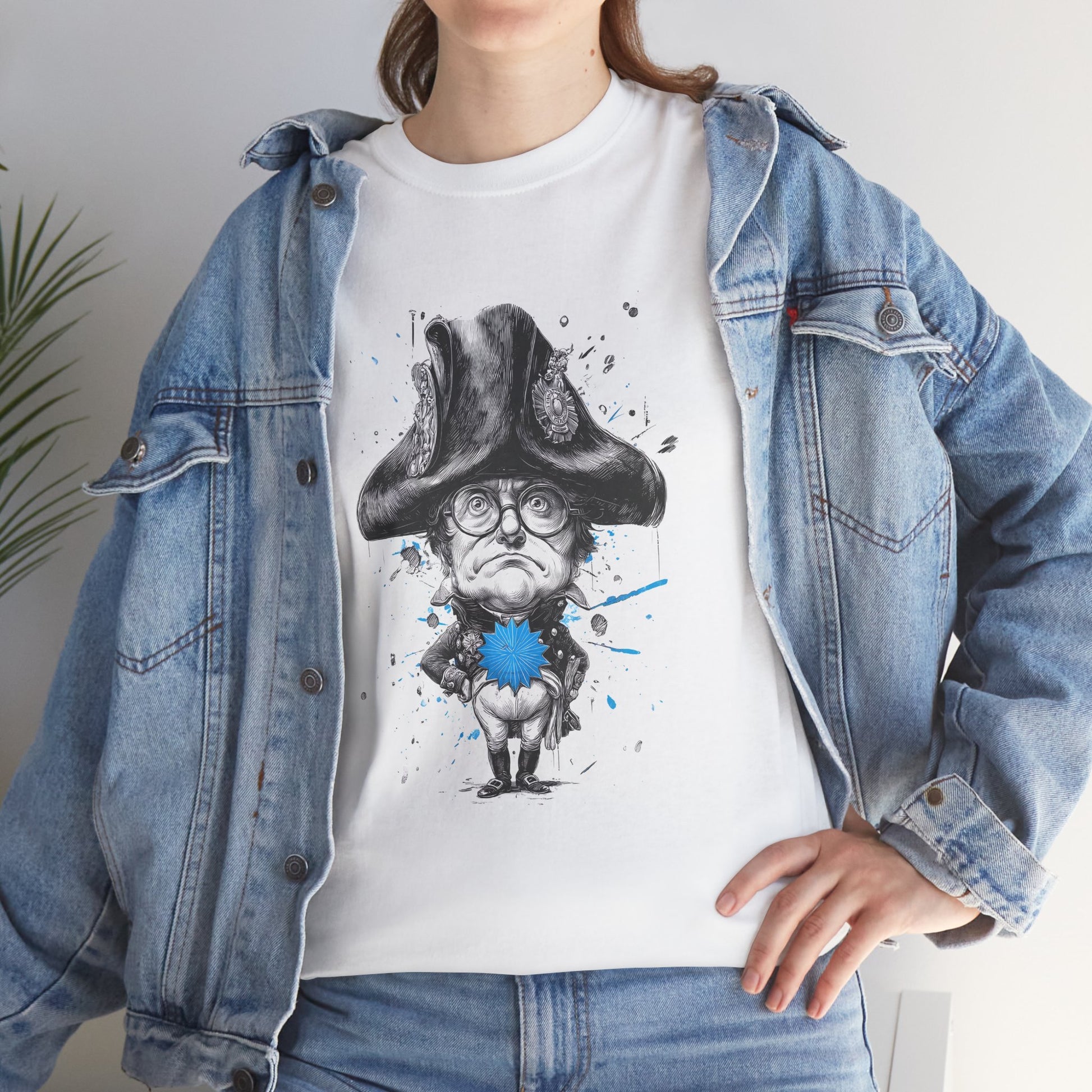 Person wearing a white t-shirt with a graphic design of a character in a hat and glasses, paired with a denim jacket.