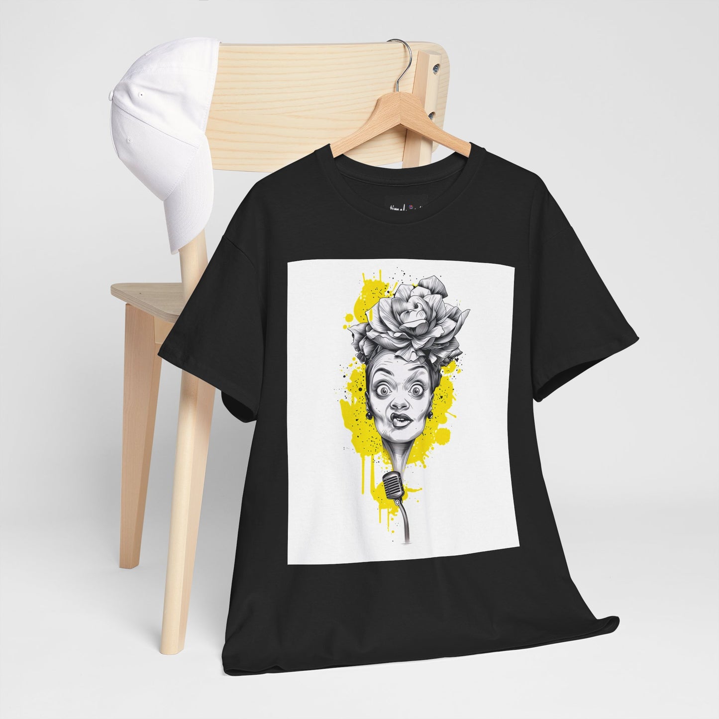 Black t-shirt with a graphic design of a woman's face with flowers on a hanger against a white background